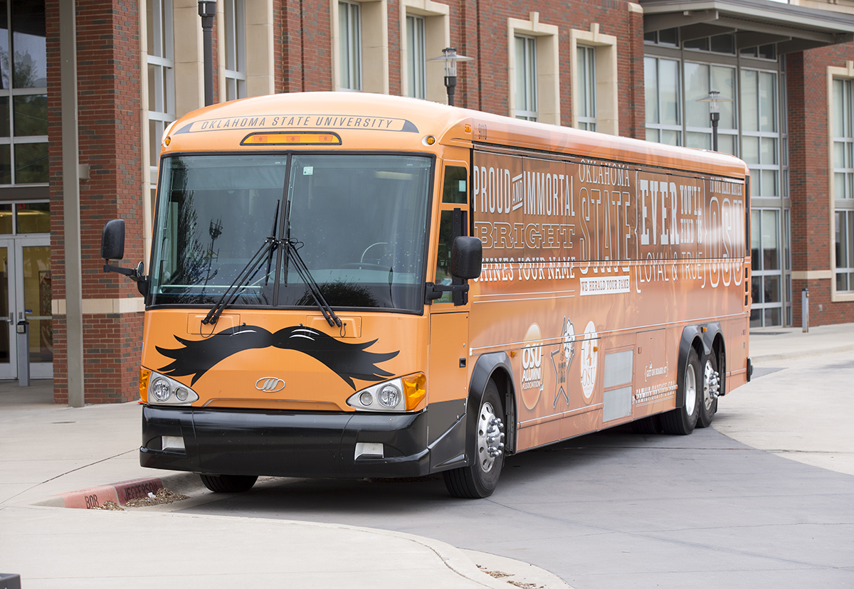 Orange bus parked on campus.