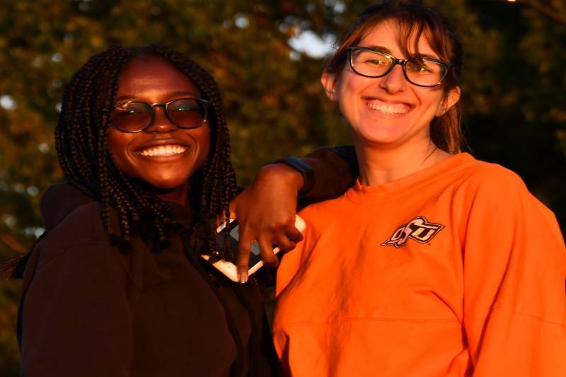 two people outside enjoying each other and posing for the picture